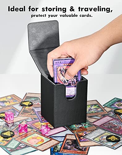 Hand placing card into black storage box surrounded by various trading cards and dice.